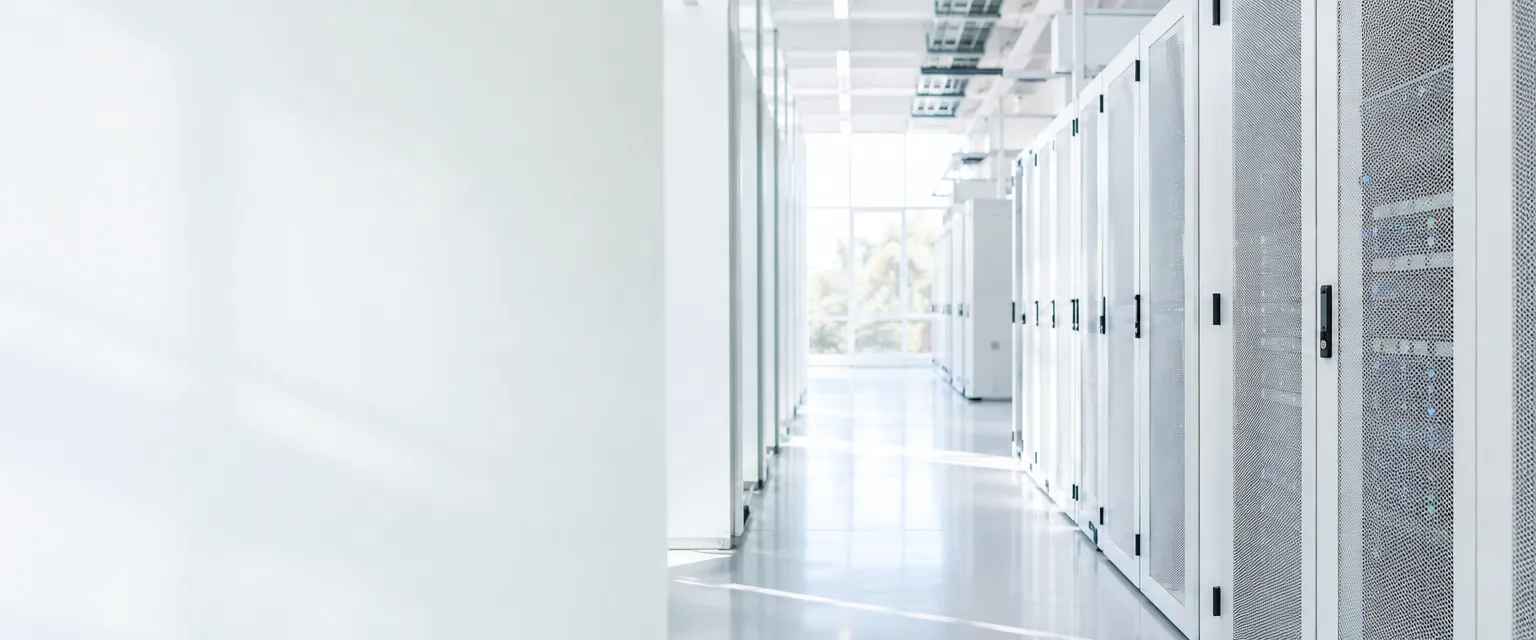 A sunlit, minimal white data-centre aisle